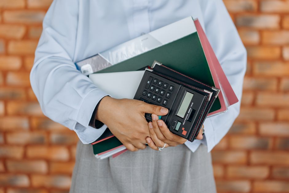 accounting professional reconciling bank transactions and ledger reports on dual monitors in a clean office environment